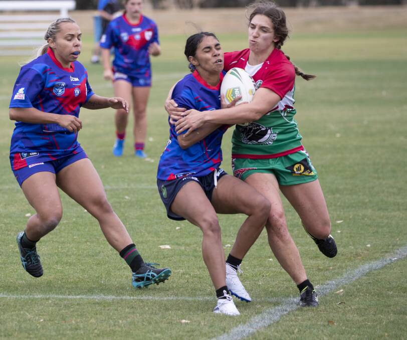 GOT YA: Kate Pevere wraps up Kangaroos playmaker Tarnayar Hinch in the first women's nines tournament on Saturday. Picture: Madeline Begley