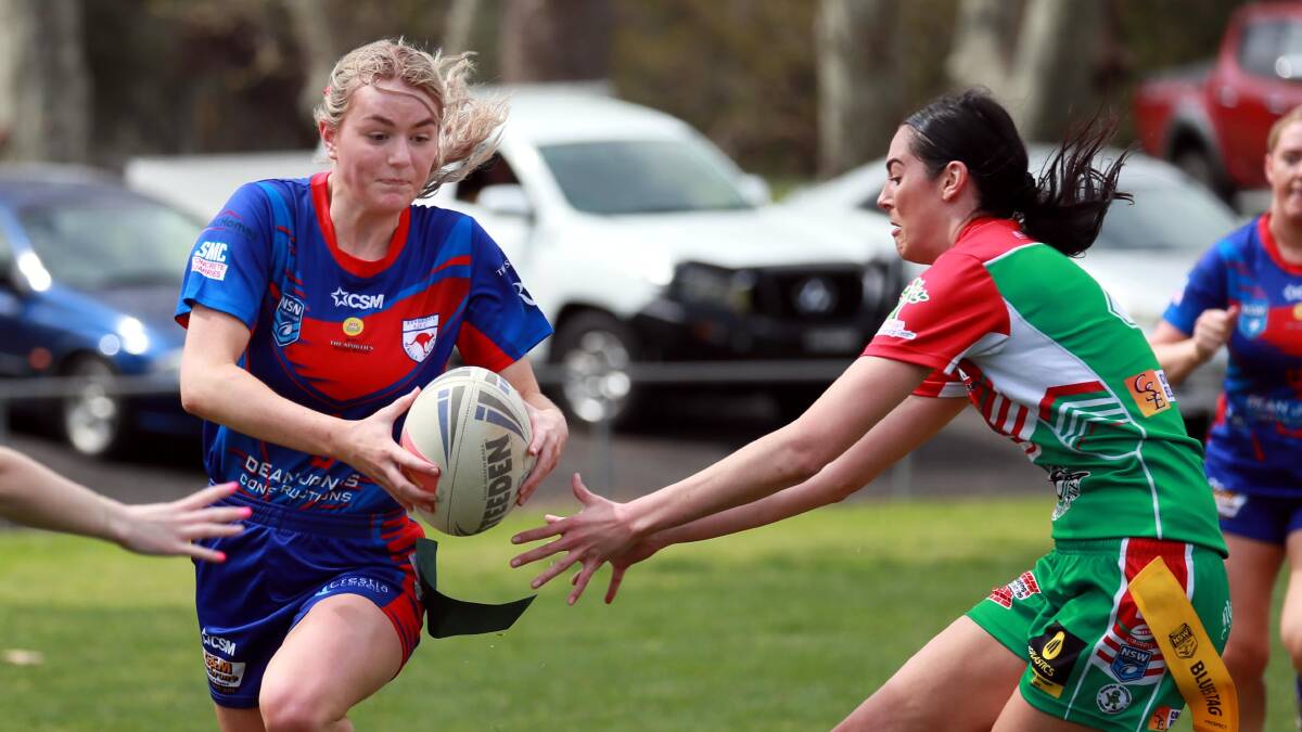 CHARGING AHEAD: Lauren Jolliffe tries to avoid Merrae Argus' atempt to tag her as Kangaroos won through to the grand final with a 14-6 win over Brothers at Anzac Park on Sunday. Picture: Les Smith