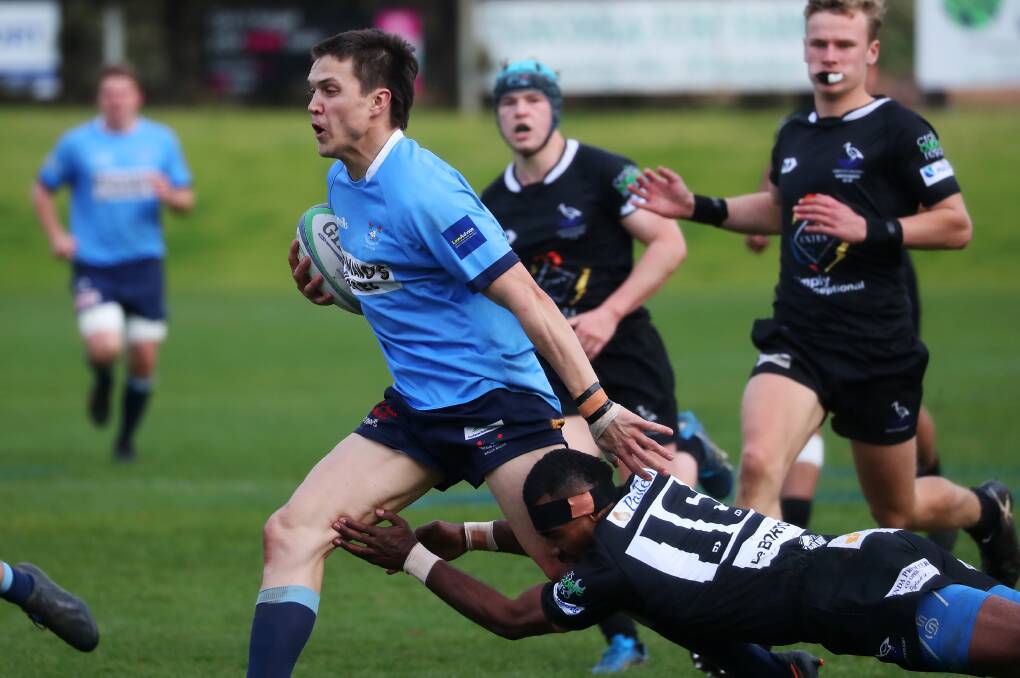 ON THE CHARGE: Harry Morrow tries to break out of a tackle as Waratahs ran out big winners against Griffith at Conolly Rugby Complex on Saturday. Picture: Emma Hillier