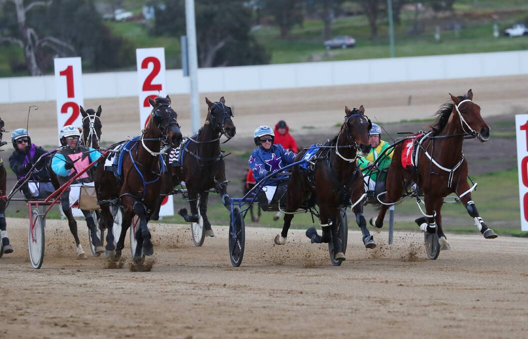 Blazin Cracker (centre) can't quite hold off Nobbys Clock's charge at Riverina Paceway on Friday.