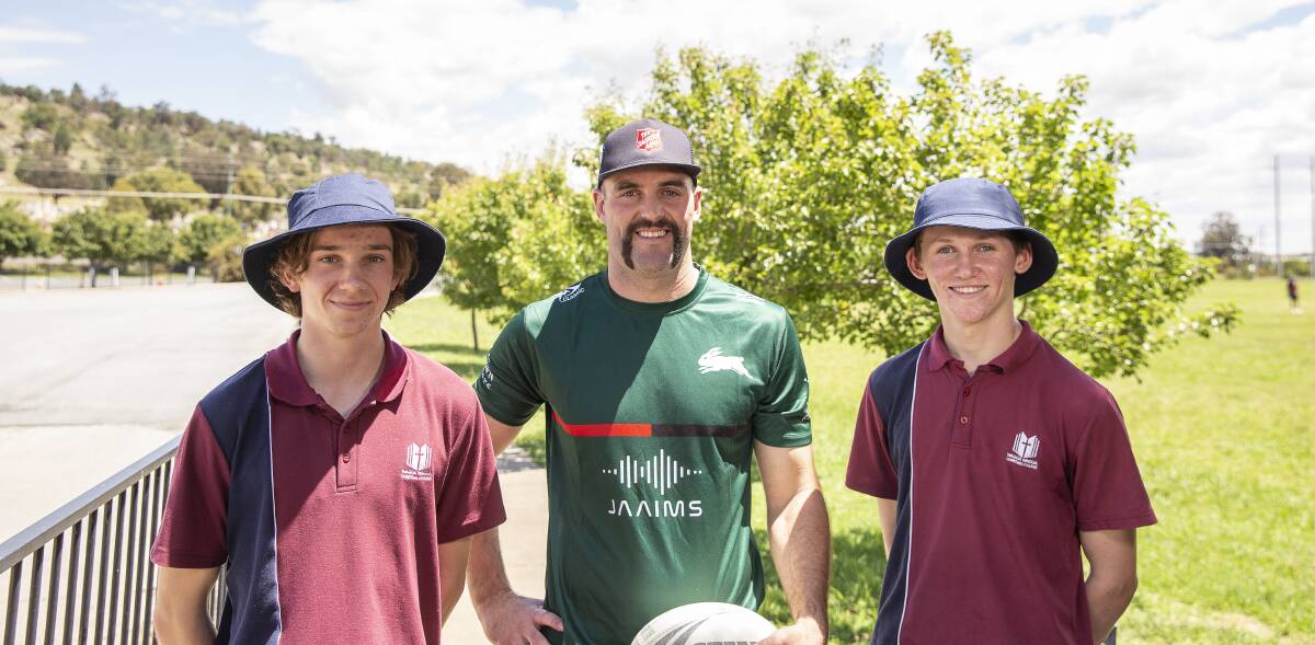 STAR ATTRACTION: Wagga Christian College students Shaun Bryder, 17, (left) and Jaymes Lee, 16, (right) with South Sydney forward Mak Nicholls on Tuesday. Picture: Ash Smith