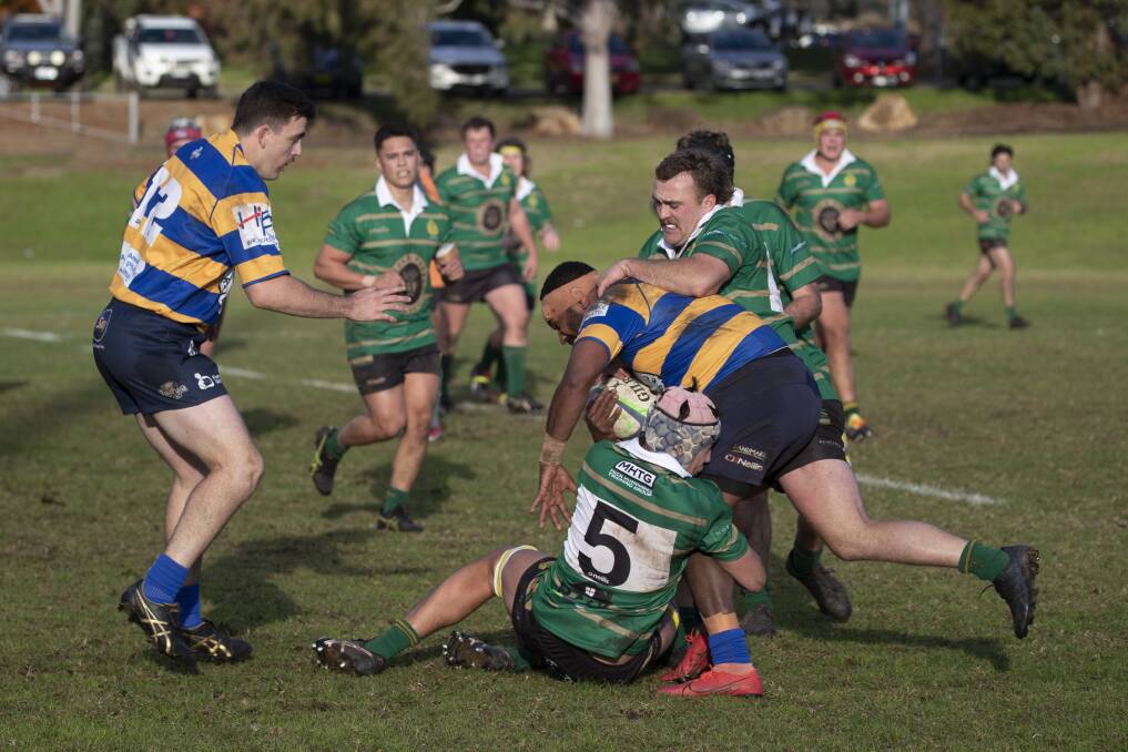 GOING DOWN: Jack Marcus and Max Gay tackle Uraia Vuluma as Ag College took an important win over Albury at Beres Ellwood Oval on Saturday. Picture: Madeline Begley