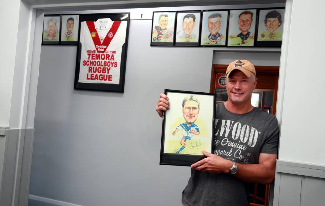 HISTORY WALL: Steve Reardon with his caricature at The Termius Hotel celebrating Temora's rich rugby league history. Picture: Les Smith