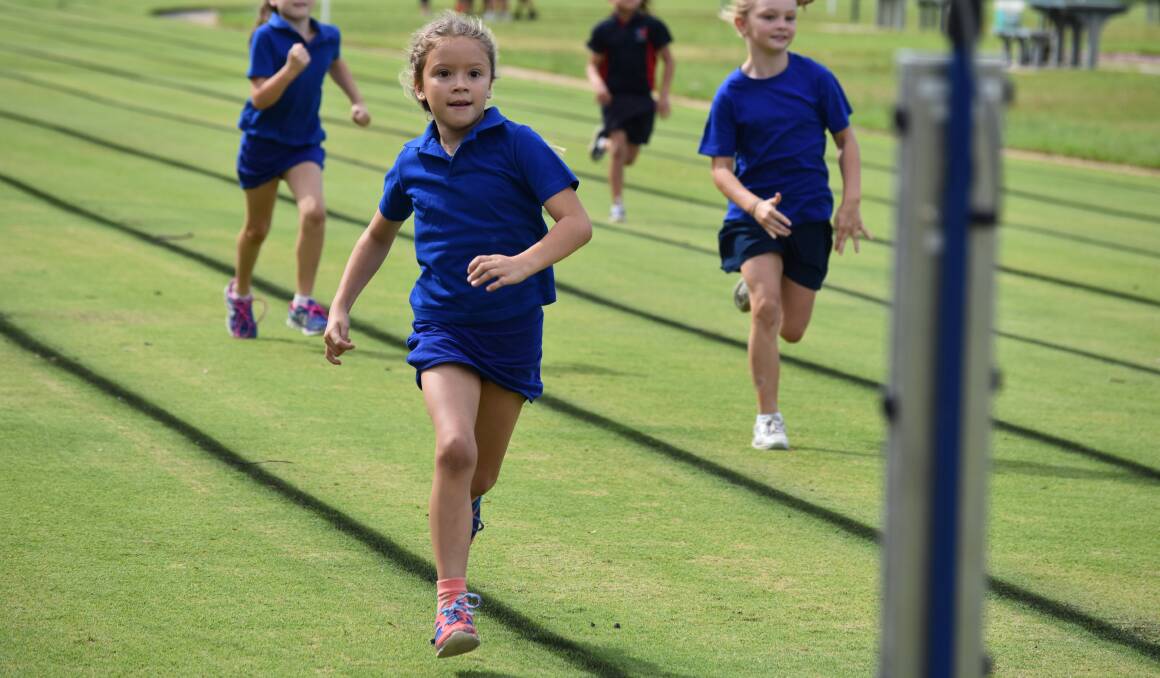 FLO JO: Florence Griffiths powers to the finish line in a eight years girls 100 metres race at the Red Hill Public School athletics carnival on Wednesday. Picture: Courtney Rees