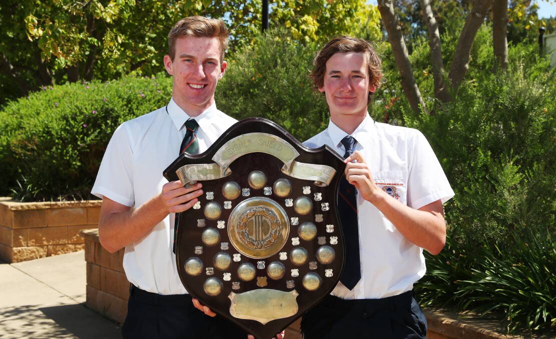 WINNERS ARE GRINNERS: Billy Glanvill and Joe Perryman proudly display the Brynes Shield after reclaiming the schoolboys cricket title in Tuesday's final win over Wagga High School. Picture: Emma Hillier