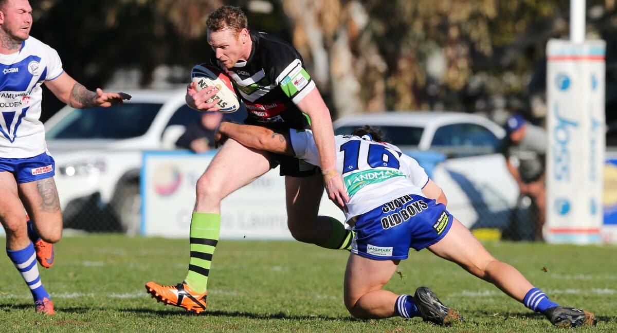 DEJA VU: Joel Monaghan tries to break out of Hayden Cowled's tackle attempt as Albury fell to another narrow this season. Picture: The Border Mail.