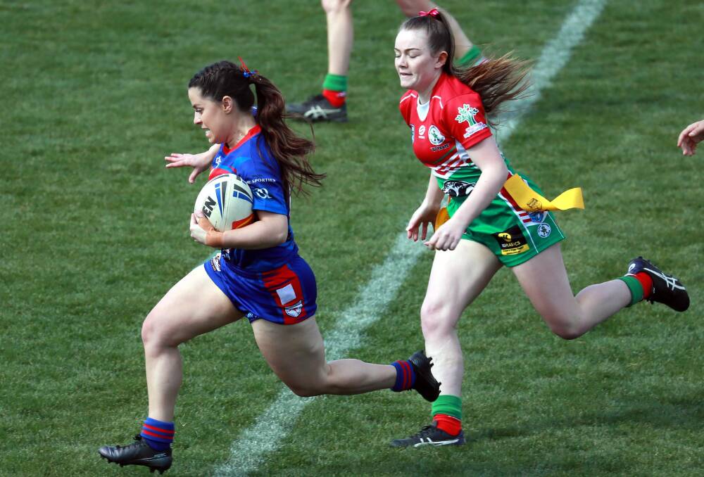 BACK IN FORM: Naomi Reid tries to keep clear of Brooklyn Phillips as Kangaroos returned to winning ways with a win over Brothers on Saturday. Picture: Les Smith