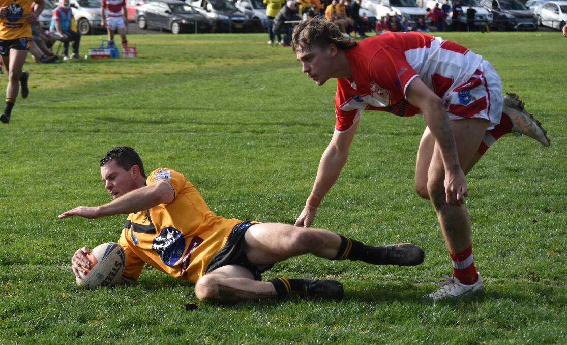TRY TIME:Derek Hay slides over extend Gundagai's lead over Temora at Anzac Park on Saturday. Picture: Courtney Rees