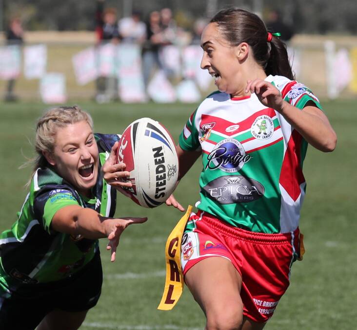 Madison Dunn, pictured about to be tagged by Jessica McDonell in last year's grand final, scored twice as Brothers scored a 24-4 win over Albury on Sunday.