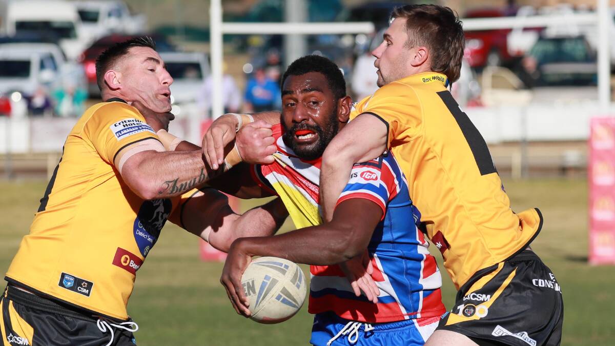TIGHT SQUEEZE: Young centre Boro Navori is wrapped up by the Gundagai defence in his side's narrow win on Sunday. Picture: Les Smith