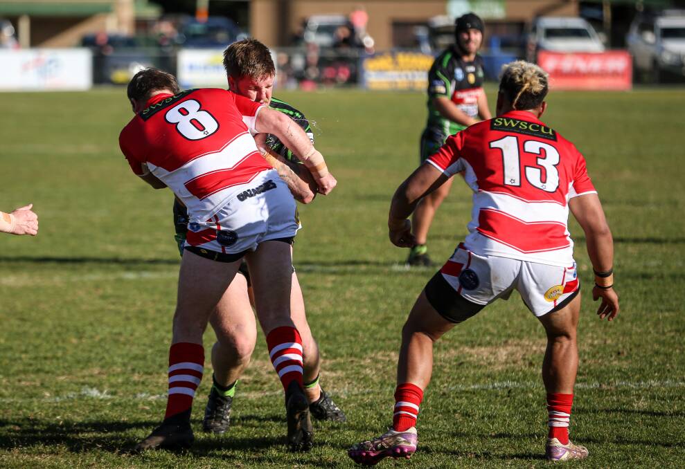 GOING NOWHERE: Reece Clegg is wrapped up by Kris Rands as Temora scored an important win over Albury at Greenfield Park on Sunday. Picture: James Wiltshire