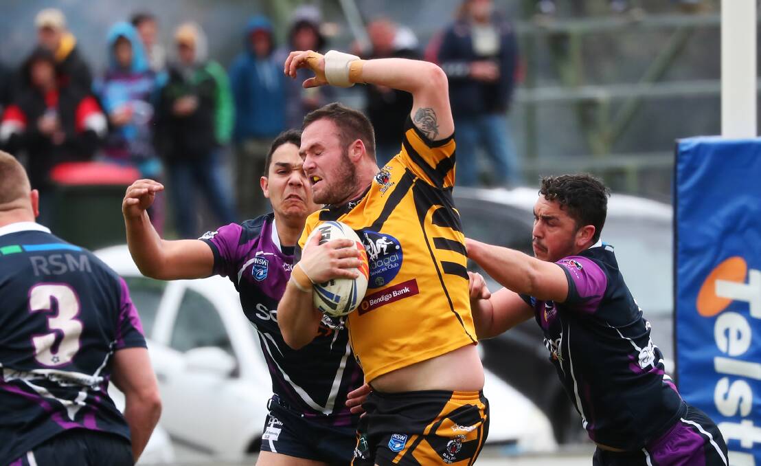 ON THE CHARGE: Gundagai prop Joel Field tries to force his way out of a tackle attempt by Latrell and Josh Siegwalt in his team's 38-0 win over Southcity. Picture: Emma Hillier