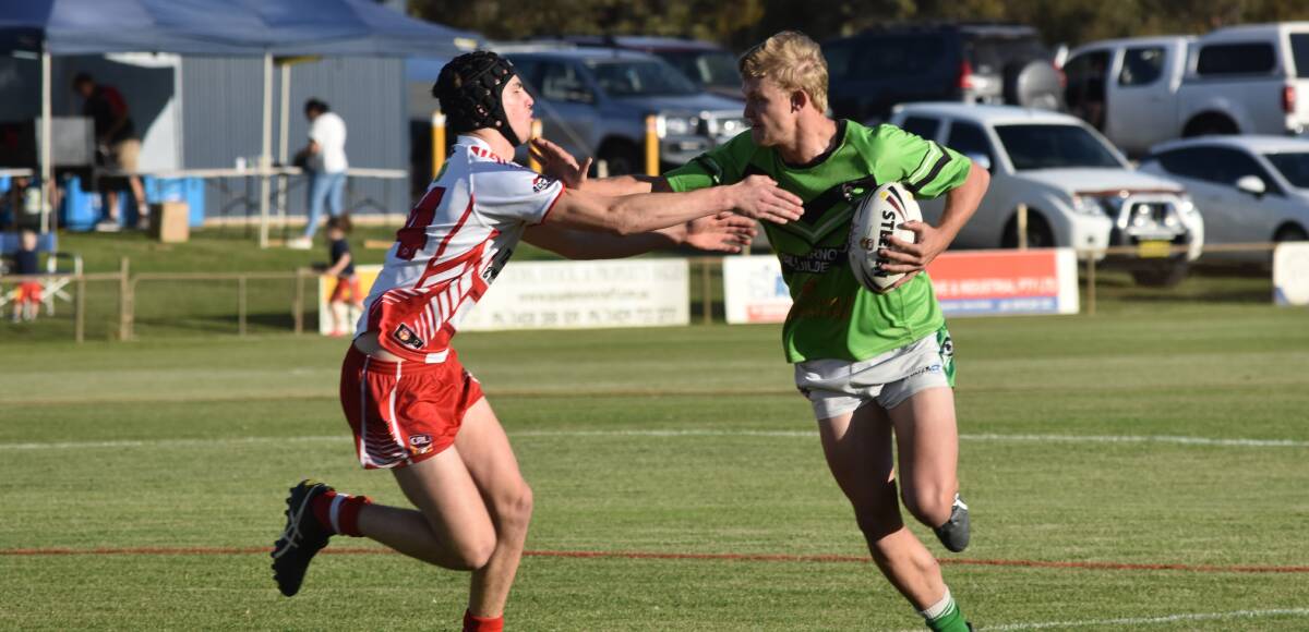 STRONG ARM: Leeton centre Josh Fisher tries to fend off
Temora counterpart Tyler Madden as the Dragons started
the West Wyalong Knockout on a
winning note on Friday. Picture: Courtney Rees