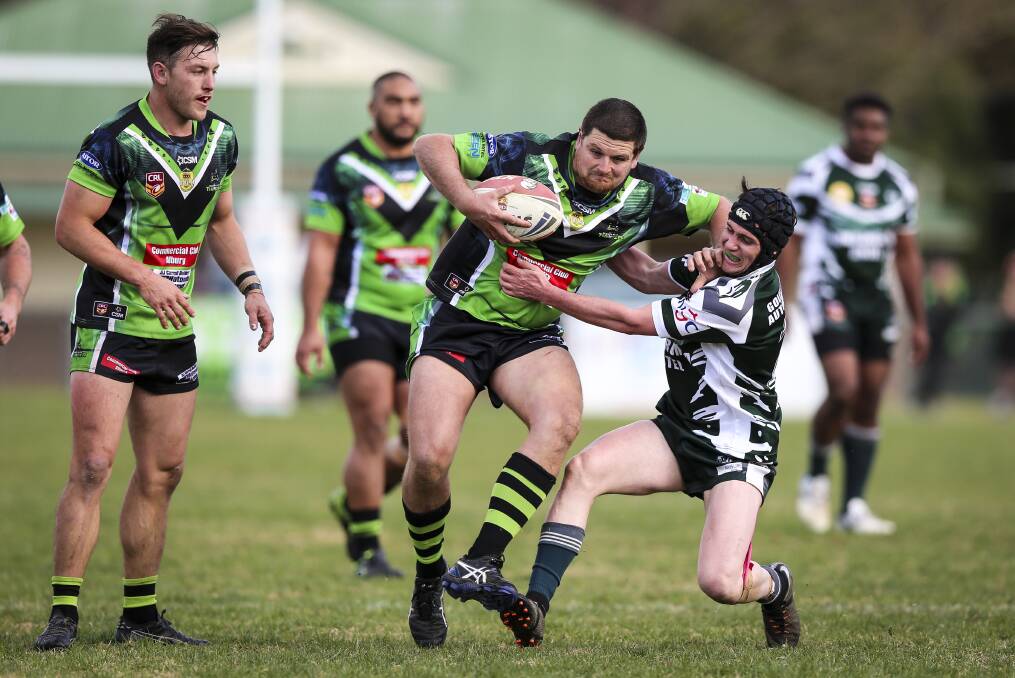 TOUGH TUSSLE: Matt Moseby tries to push off Kane Hammond's tackle attempt during Albury's much-needed win over Tumbarumba at Greenfield Park on Saturday. Picture: The Border Mail