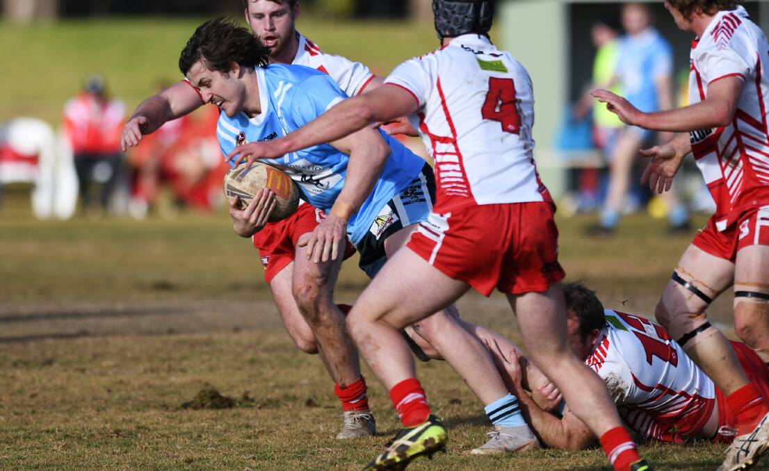 CHARGING AHEAD: Jed Pearce tires to bust out of Kris Rands' tackle attempt in Tumut's win over Temora at Nixon Park on Sunday.