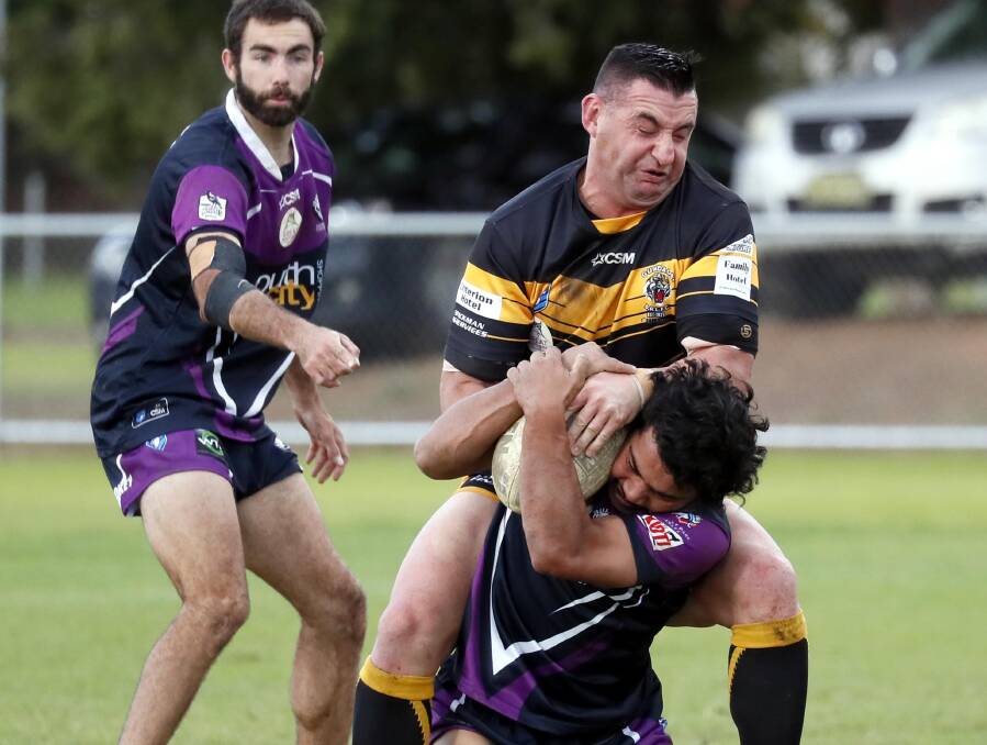BATTLE IS ON: Damian Willis and Steven Tracey both look to control the ball in Gundagai's win over Southcity at Harris Park on Sunday. Picture: Les Smith