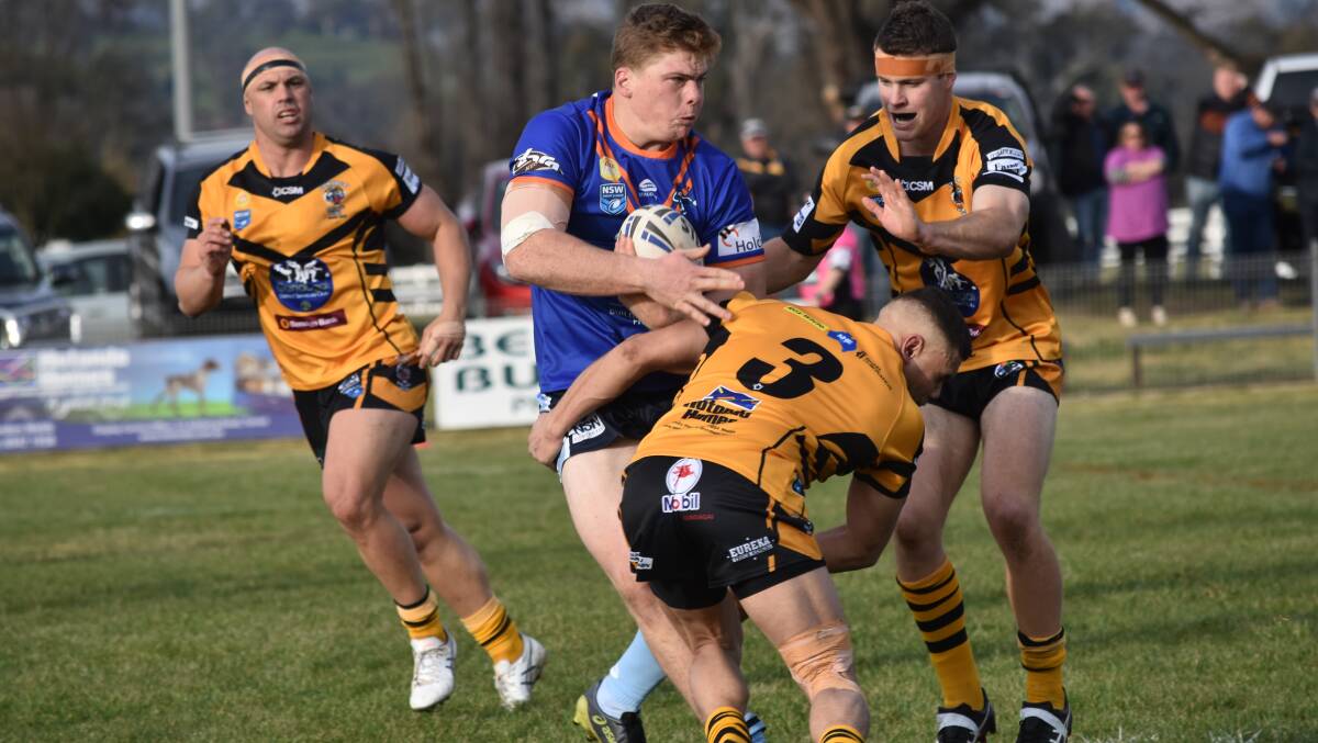 Derek Hay (right), pictured trying to stop Michael Fenn, made his return to Gundagai in the draw with Tumut last week.