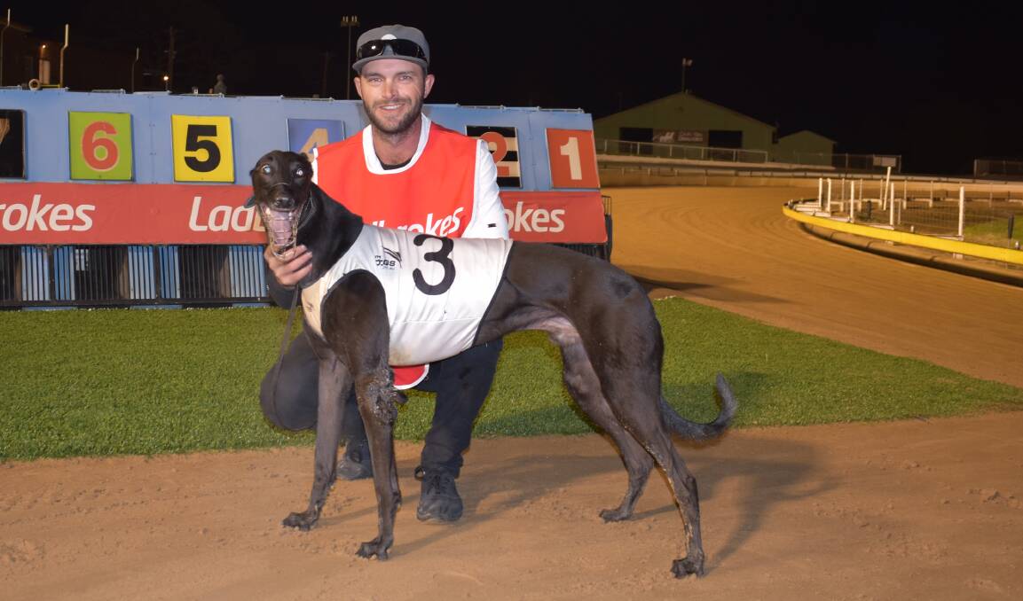 SWEET SUCCESS: Handler Lloyd Kimber with Corleone King after winning his heat of the Wagga Gold Cup on Friday night. Picture: Courtney Rees