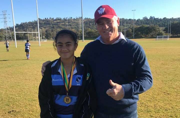 SPECIAL EFFORT: Tausala Samu is congratulated by Chris Mortimer for winning the Rick Keast Medal for her performance in the tackle competition.