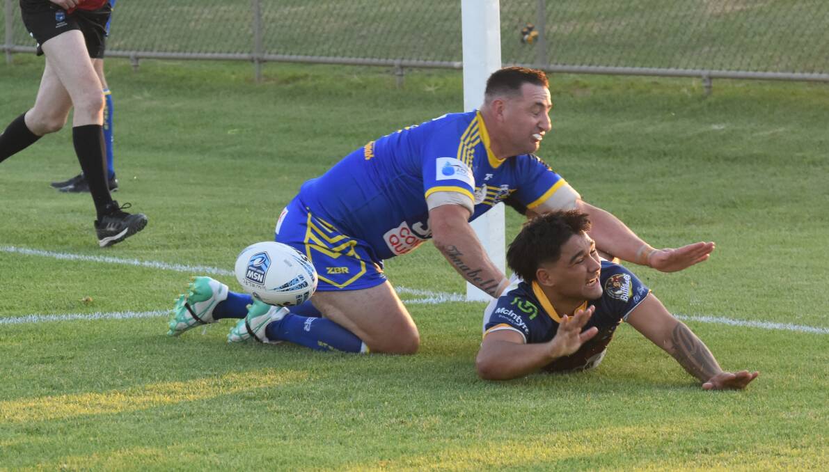 Damian Willis can't stop Jacob Haeato scoring the first of his two tries.