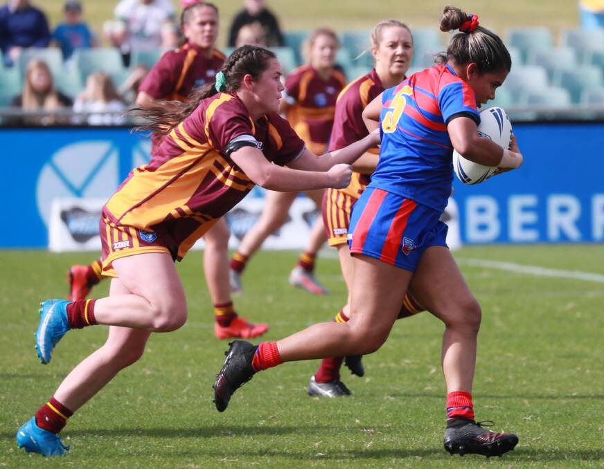 Tess Staines tries to bring down a Newcastle opponent in Riverina's heavy loss in the Country Championship final in May.