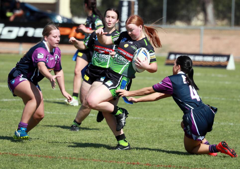 Brooke Thompson tries to find space between Southcity defenders Jemma Davey and Shanae Freeman in Albury's win at Harris Park on Sunday. Picture: Les Smith