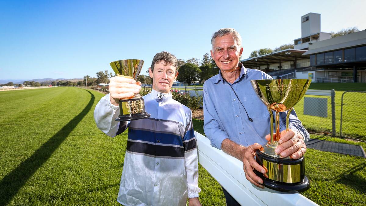 GOLDEN MOMENT: Mathew Cahill and Ron Stubbs with the spoils of Spunlago's victory in the Albury Gold Cup on Friday. Picture: James Wiltshire