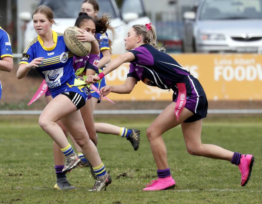 CAUGHT: Macey Crane tries to escape Hayley Hinds as Southcity reversed the earlier result against Junee to take a 20-10 win at Harris Park on Sunday. Picture: Les Smith