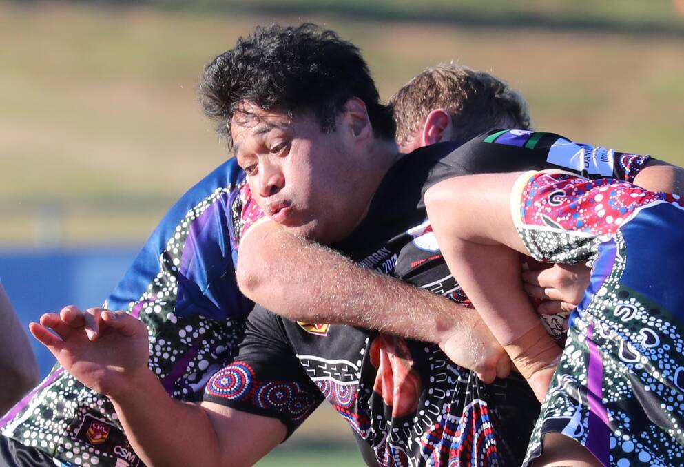 TOUGH TASK: Sione Niuila gets wrapped up by the Southcity defence during Kangaroos big loss at Equex Centre on Saturday. Picture: Les Smith