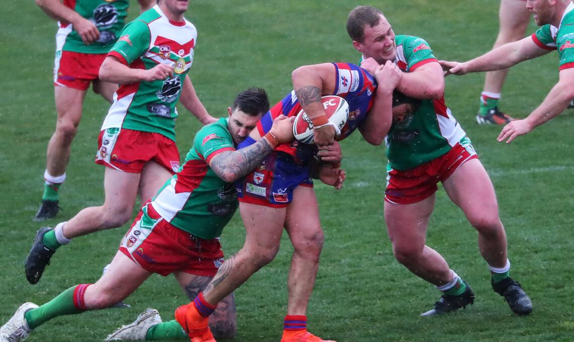 GRABBING HOLD: Brayden Sharrock and James Hay work to bring down Dana Ratu in Brothers win over Kangaroos on Saturday. Picture: Emma Hillier