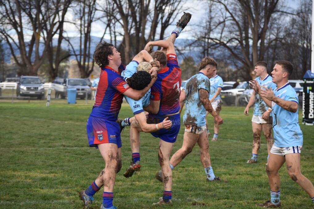 TIPPING OVER: Ben Pembleton and Jake Mascini lift Mitch Ivill into an awkward position in Tumut's win over Kangaroos at Twickenham on Saturday. Picture: Courtney Rees