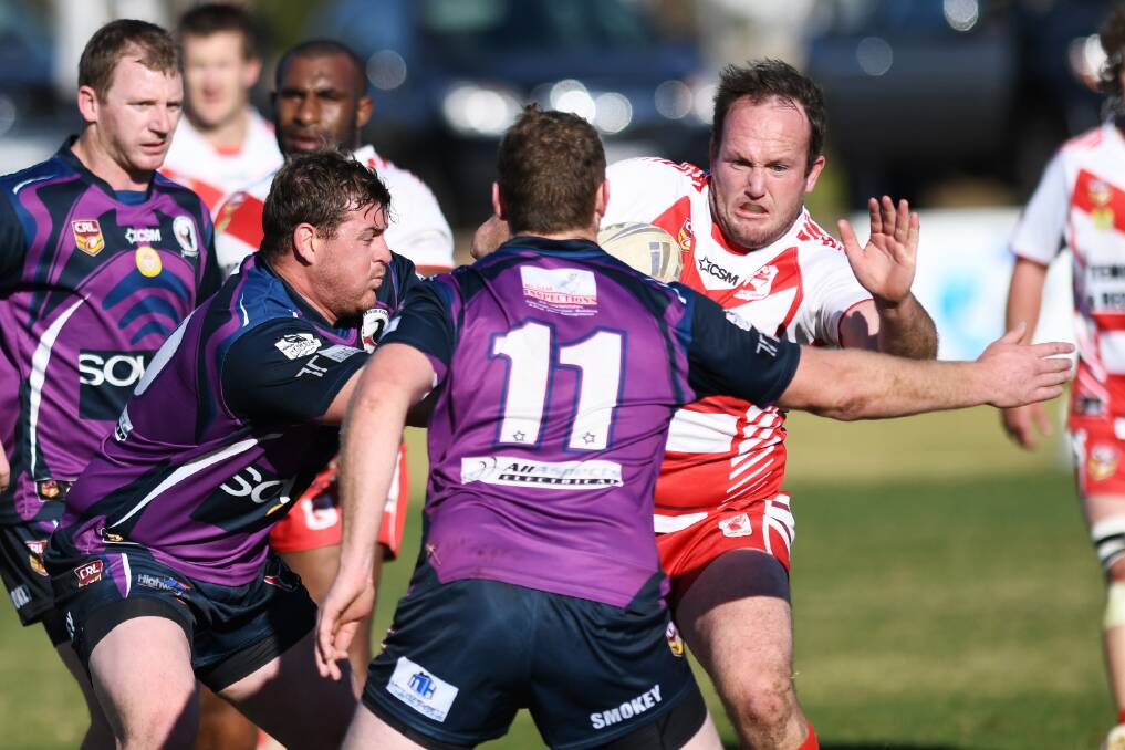 Cameron Copeland and Tim Hurst look to stop Kris Rands in Southcity's win over Temora at Harris Park on Sunday.