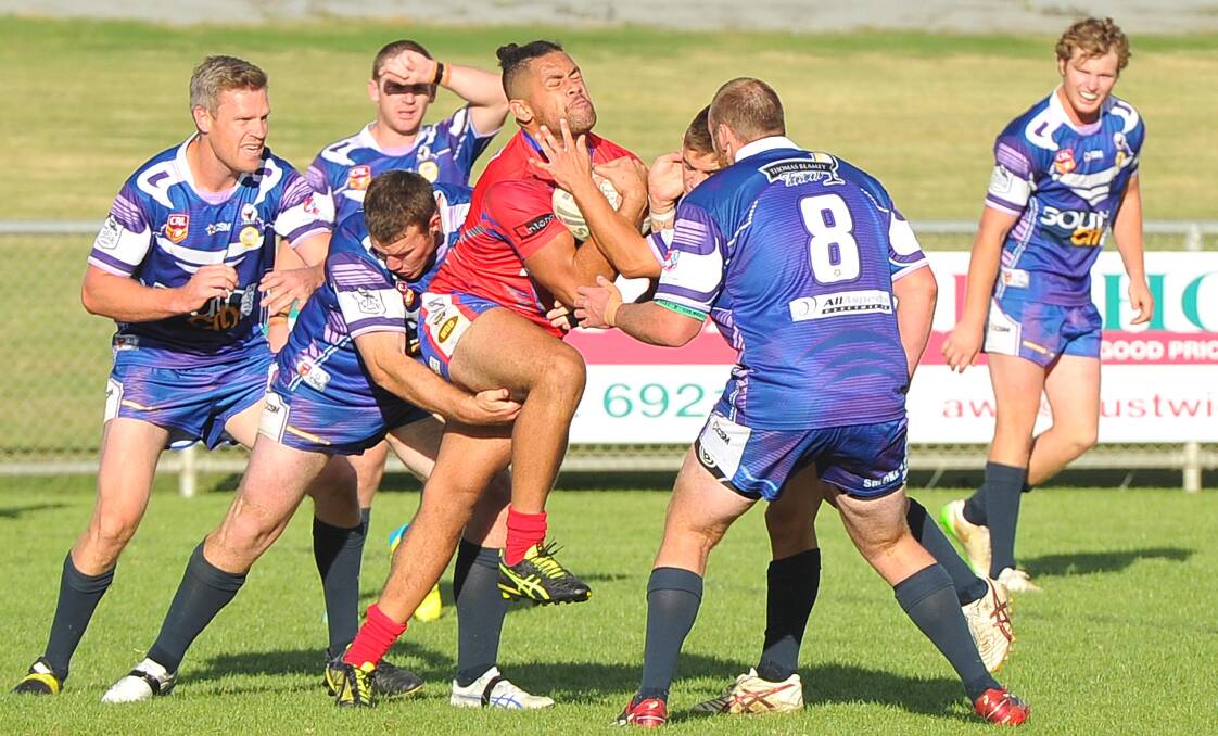 FULL FORCE: Three Southcity defenders look to bring down Kangaroos winger Eddie Lagaali as they got the better of Kangaroos. Picture: Kieren L Tilly