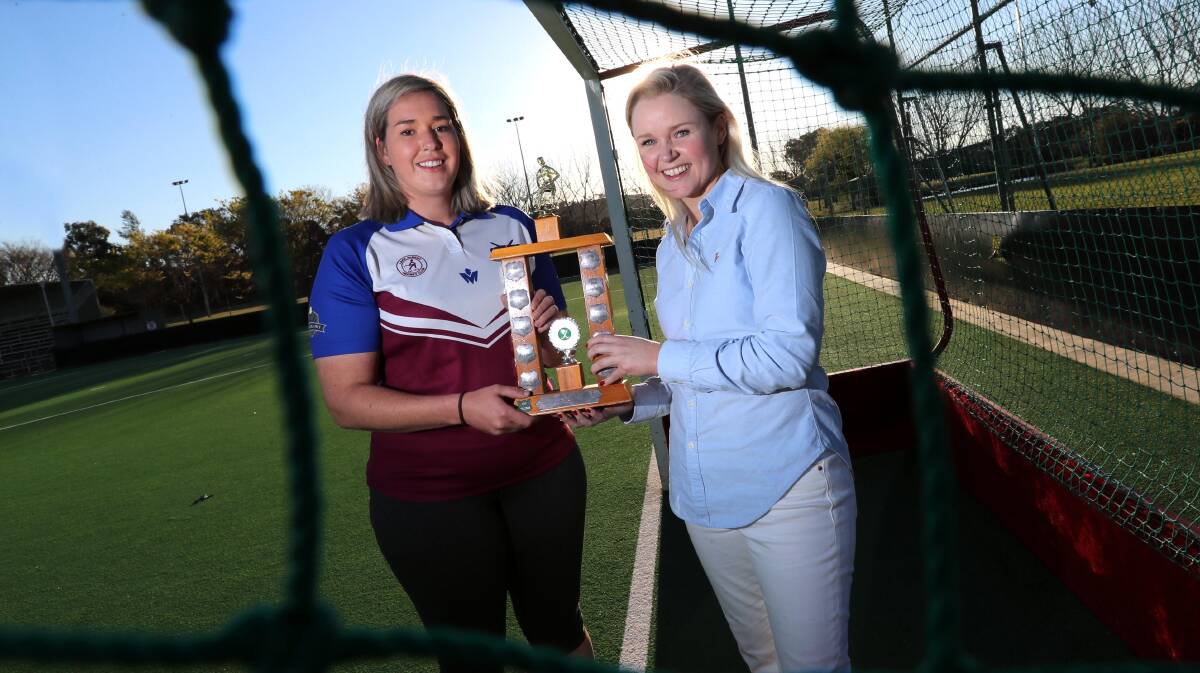 READY TO BATTLE: LAC United captain Jesse Thompson and Royals counterpart Emily Paul with what both teams are playing for in the division one grand final on Saturday. Picture: Les Smith