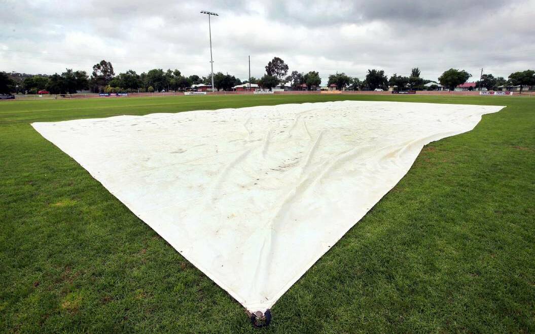 EYES ON THE SKY: The Harris Park wicket is covered after wet weather forced round one to be washed out earlier this season. More rain is forecast this weekend after last weekend's washout. Picture: Les Smith