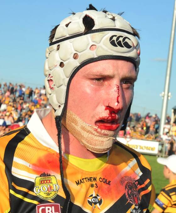 HARD DAY'S WORK: A bloodied and bruised James Luff after the 2015 grand final win.