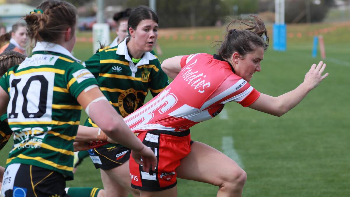 Ellen McInytre tries to break out of a tackle during the last meeting between the two sides.