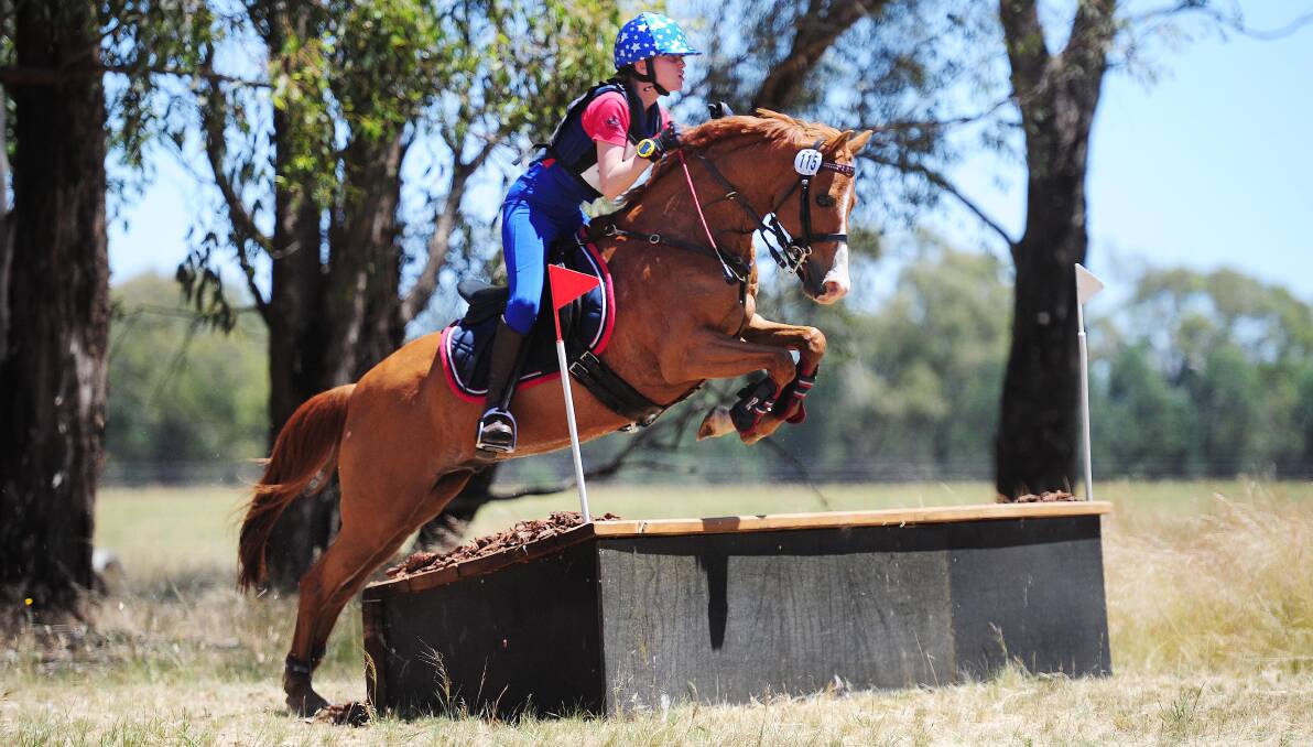 GOING CLEAR: Alexandra Cloros flies over the cross country course with Play It Again Of Astral during the REA Horse Trials. Picture: Kieren L Tilly