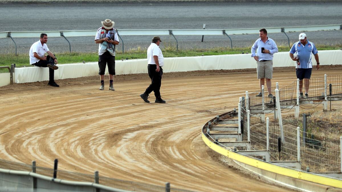 CAUSE FOR CONCERNS: Officials inspect the track after stewards deemed it unsafe for racing and abandoned the 11-race card on Thursday. Picture: Les Smith
