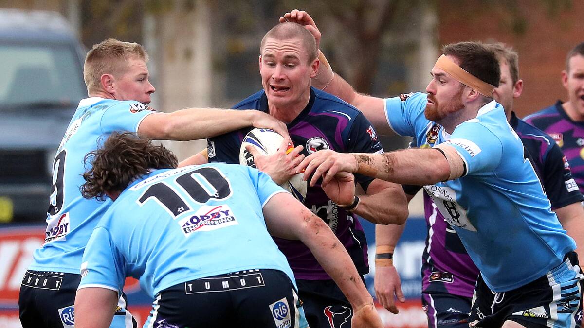 CLOSING IN: Nick Skinner is surrounded by Tumut defenders as the Blues scored a 16-10 win over Southcity on Sunday. Picture: Les Smith