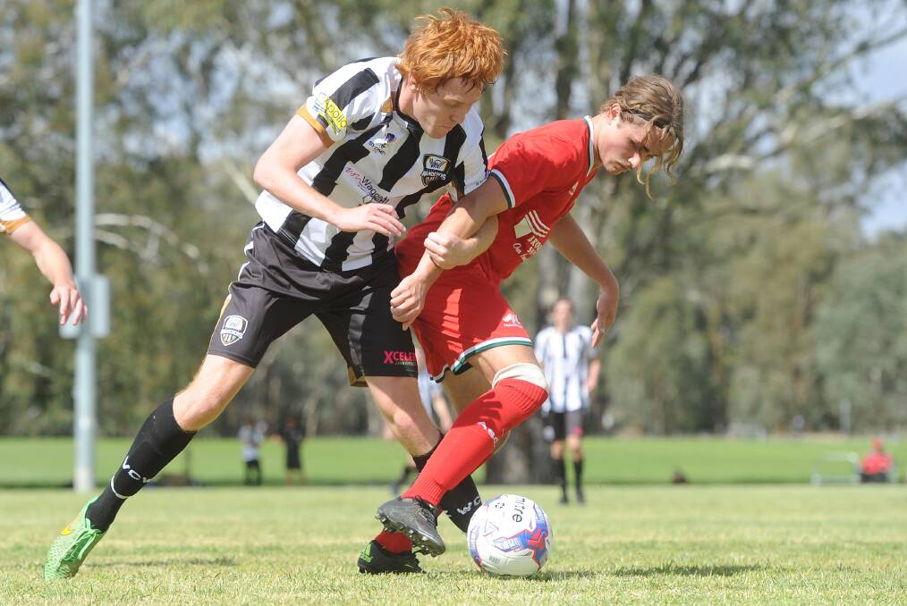 Tyler Allan battles with Kade Roberts when the Wagga City Wanderers hosted Avalon in the FFA Cup in 2017.