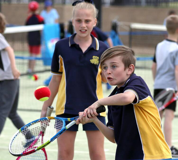 TOP SHOT: South Wagga's Lenny Piper, 10, hits a volley as doubles partner Milla Pavitt watches on in the Todd Woodbridge Cup Riverina final at Jim Elphick Tennis Centre on Wednesday. Picture: Les Smith