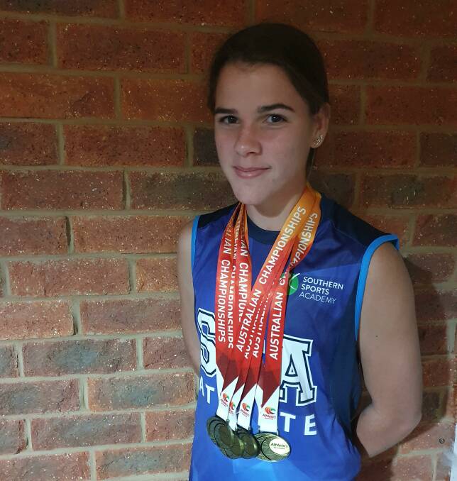 Indi Cooper shows off her swag of medals from nationals.