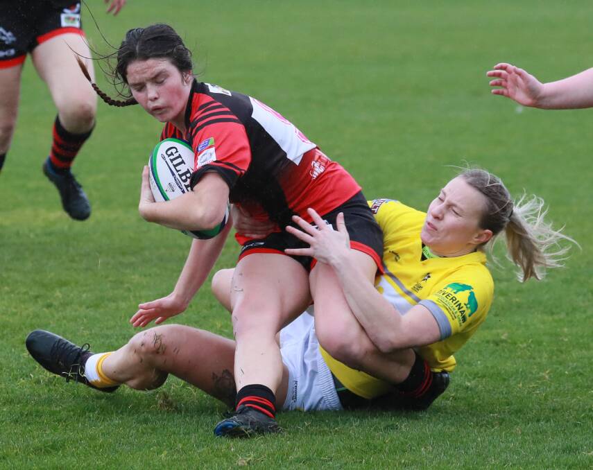 GOING DOWN: Georgia Roberts tries to stop Kym Brain in Ag College's win over Tumut at Conolly Rugby Complex on Saturday. Picture: Les Smith