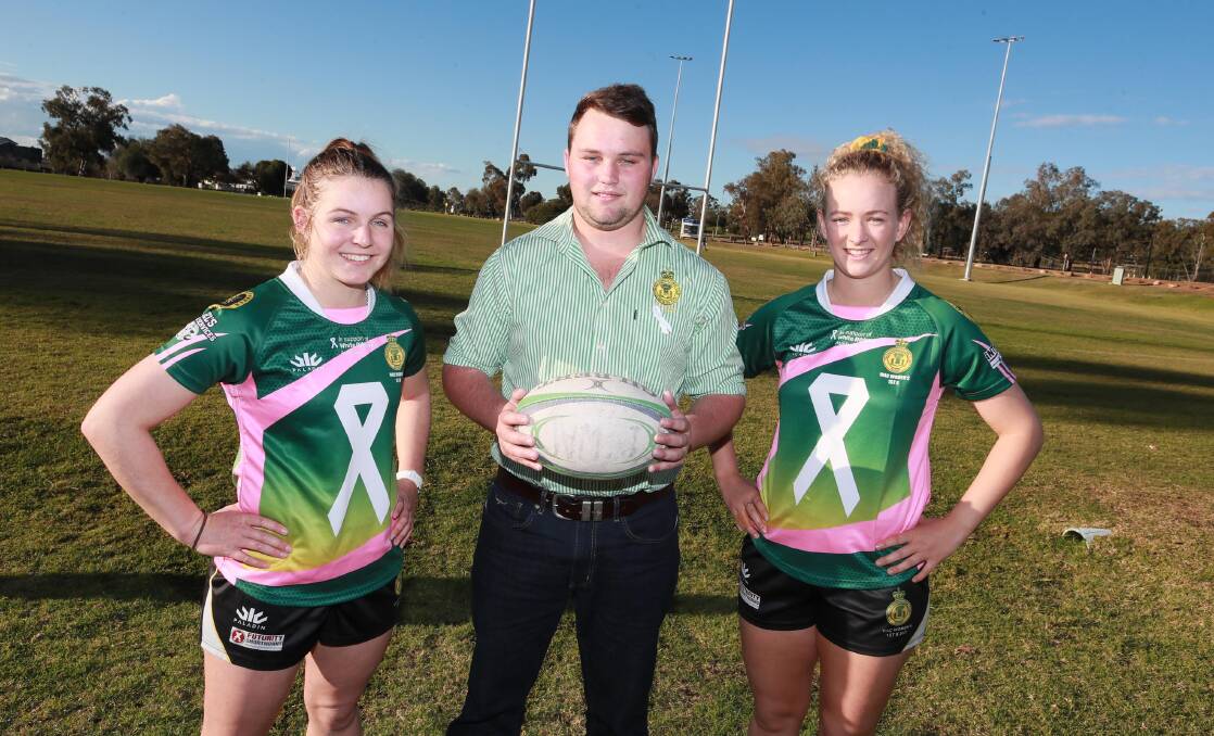 CHANGING TIMES: Jess Ryan (left) and Ellie Burnett (right), with Ag College president Pat Lemmich, are looking to put in a big display after being made the feature game at Beres Ellwood Oval on Saturday. Picture: Les Smith