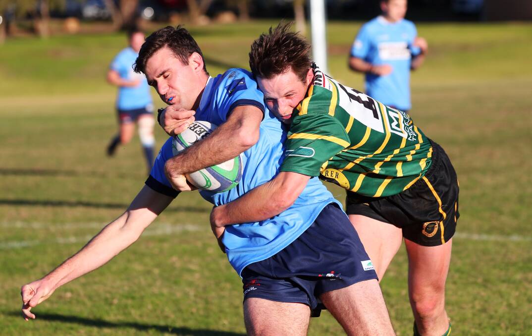 GOT HIM: Waratahs fullback Rob Selosse is caught by Ag College counterpart Lachlan Woods at Beres Ellwood Oval on Saturday. Picture: Emma Hillier