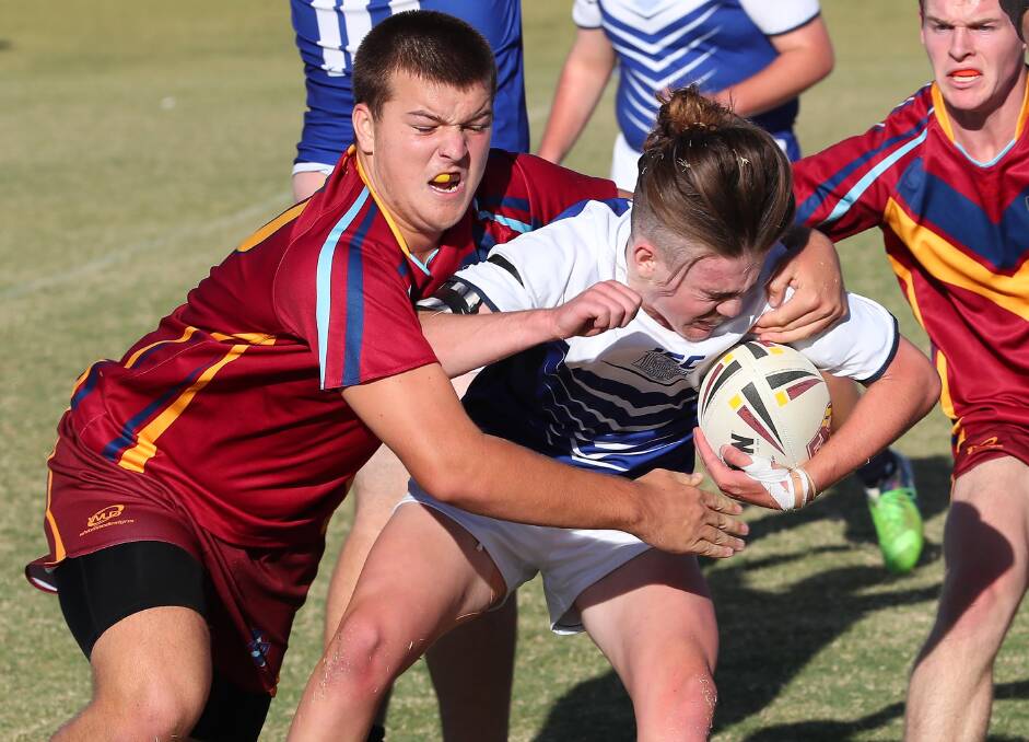 ALL WRAPPED UP: Wagga High hooker Zac Delaney tries to break free of a tackle during his team's loss to Mater Dei in the opening round of the Hardy Shield on Tuesday. Picture: Kieren L Tilly