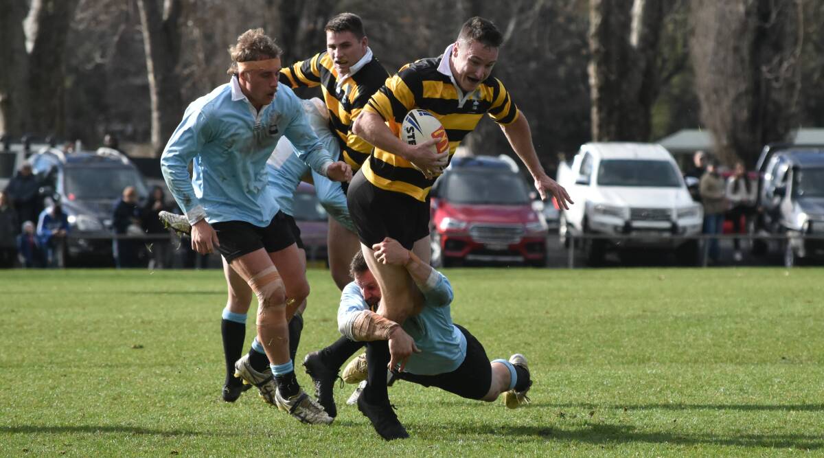 HOLDING ON: Adam Pearce just manages to bring down Dane O'Hehir in Tumut's win over Gundagai at Anzac Park on Saturday. Picture: Courtney Rees