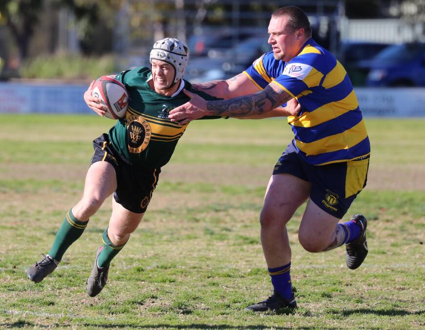 DAVID AND GOLIATH: Cameron Duffy tries to fend off Tim Carroll in Ag College's win over Albury in the preliminary final at Exies Oval on Saturday. Picture: Les Smith