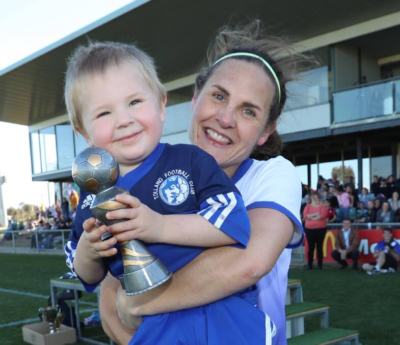 Bernadette Blake, with son Daniel, 3, was named best on ground in the decider.